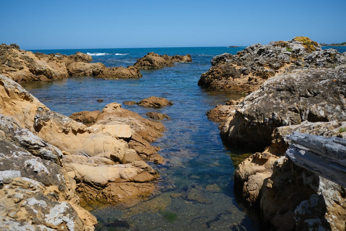 A view of the ocean from a rocky shoreline