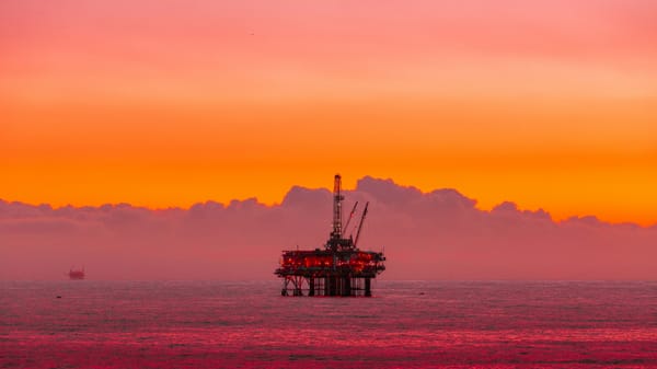 An oil rig at sunset.